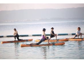 While taking a sunrise Sunrise SUP yoga experience at the beach! Image of