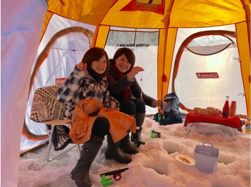 Two women enjoying a smelt fishing experience at Sapporo "SAN (SAPPORO ACTIVE NAVIGATION)"