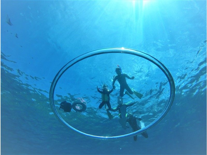 A family enjoying Okinawa's Blue Cave snorkeling tour with Muto Diving