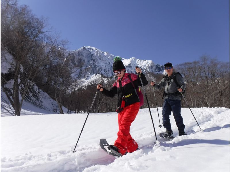 Winter date couple enjoying snowshoeing