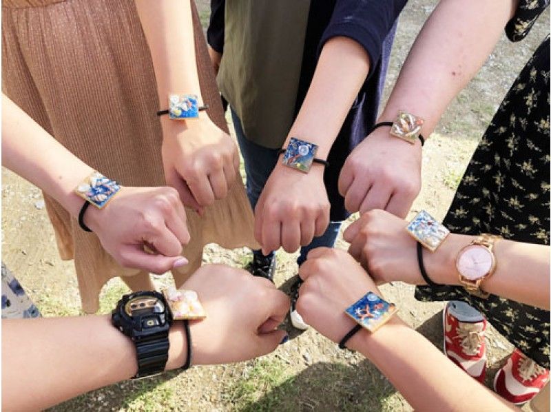 A group of women enjoying making hair ties at Okuma Navi