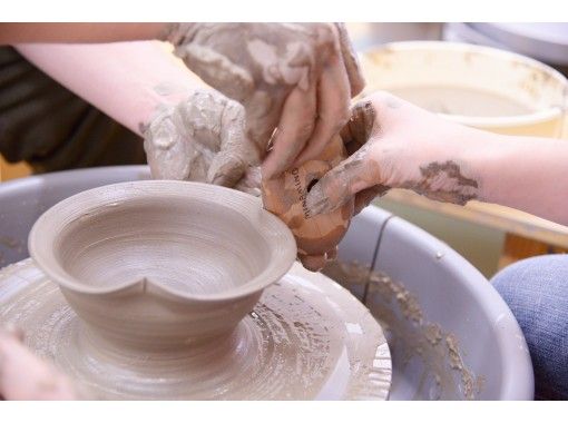 Premium Photo  Freshly made clay pot on a potters wheel