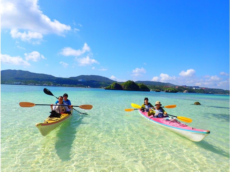 A family enjoying a deserted island sea kayaking tour with Earth Ship Okinawa