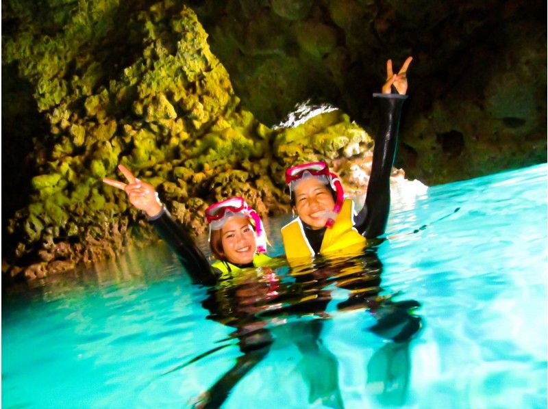 A woman enjoying blue cave snorkeling at Okinawa diving shop Sea Mall