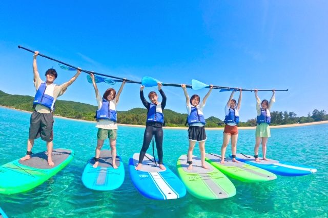 Young people enjoying a SUP experience at Amami Sealand on Amami Oshima