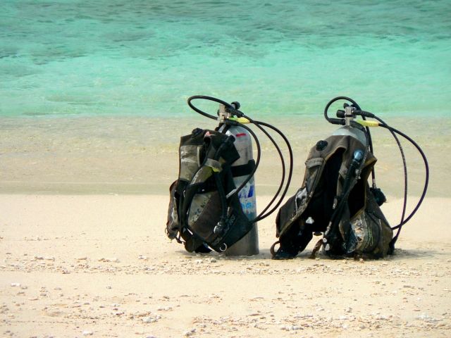 Oxygen cylinder for scuba diving placed on the beach