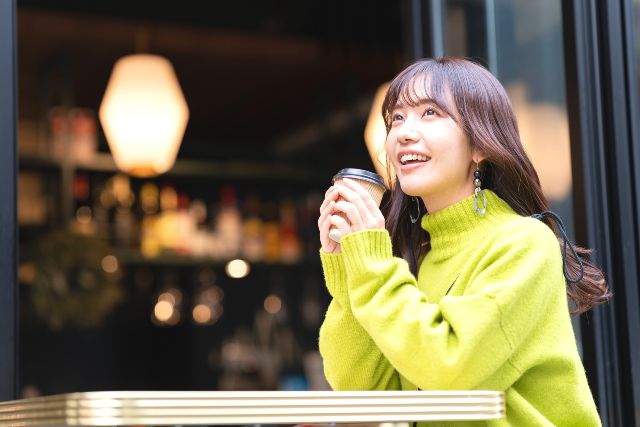 A woman enjoying her day off alone relaxing at a cafe