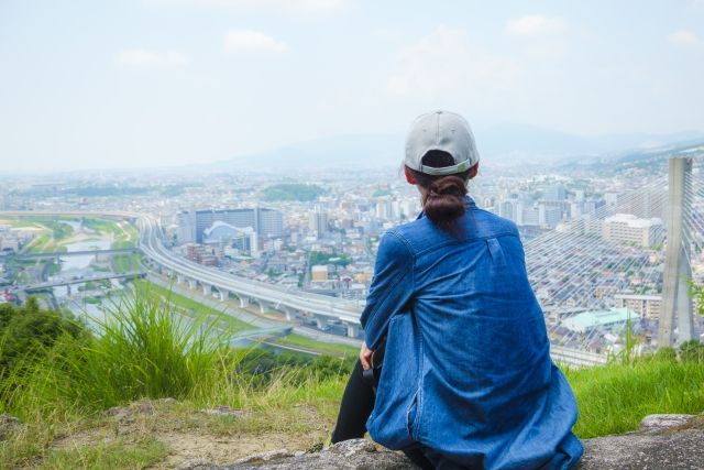 Rear view of a woman looking at the view from Satsukiyama in Ikeda City, Osaka Prefecture