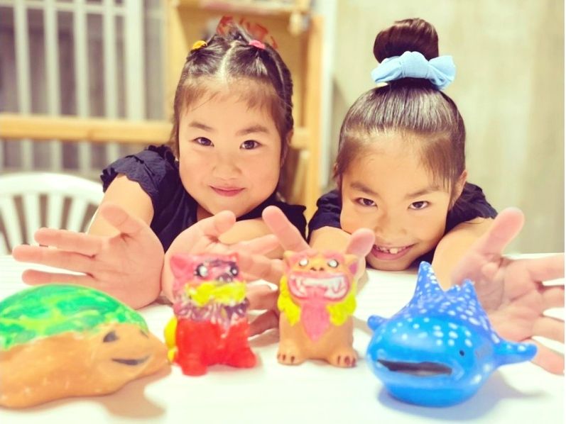 Cheerful Children enjoying Shisa coloring experience in Miyakojima