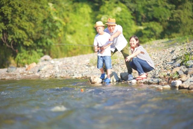 Family enjoying mountain stream fishing