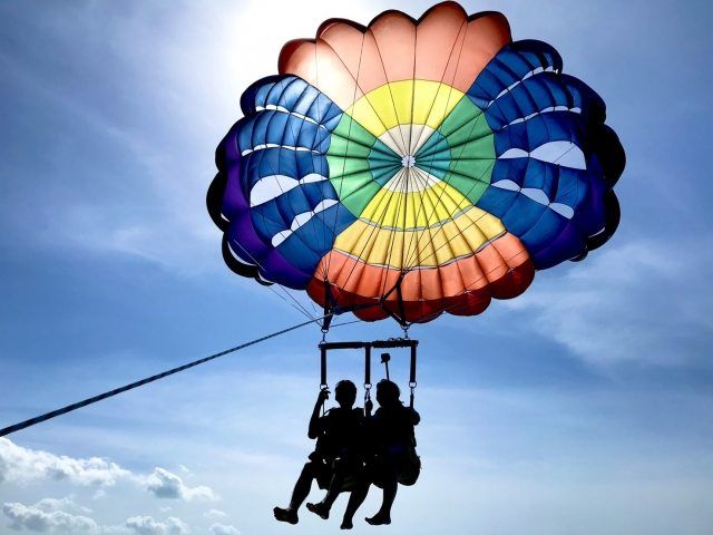 People enjoying parasailing in Okinawa