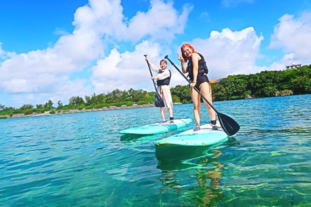 Okinawa, Oujima "Okinawan SUP" A duo of women enjoying a SUP experience