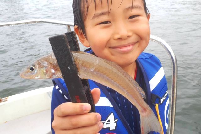 "PLAYFUL FISHING" Children enjoying the experience of fishing for flatfish