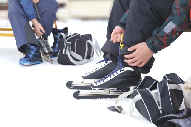 Parents and children tying skate laces