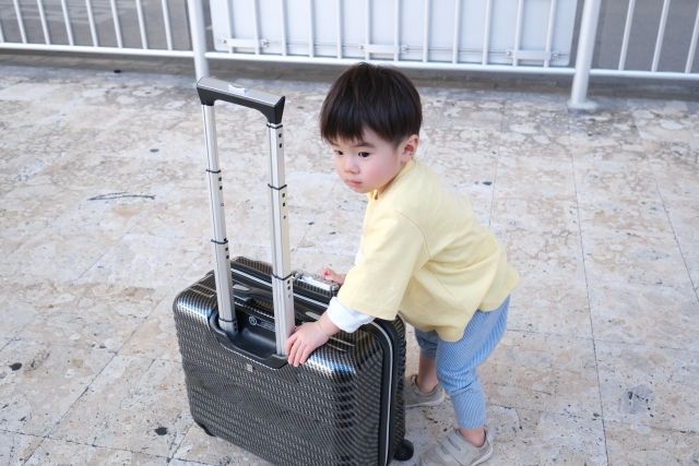 Toddler touching travel carry case